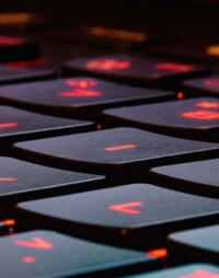 A close photo of a black keyboard with red keys